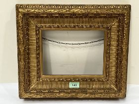 A Victorian picture frame. 13¾" x 16" overall. Aperture 7" x 9".