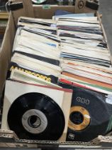 A box of over 250 1980s 7" vinyl records.