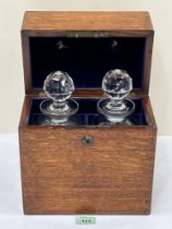 A 19th century oak decanter chest fitted with a pair of glass decanters. 11" high.