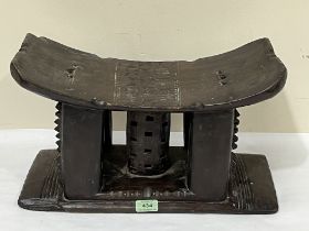 An African tribal carved hardwood stool or head rest. 18" wide.