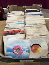 A box of over 250 1970s 7" vinyl records.