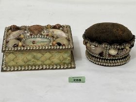 An early 20th century shellwork trinket box, 7" wide and a pin cushion.