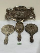 An Edward VII silver dressing table tray, repousse decorated with angels after Sir Joshua