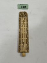 A 19th century carved bone cribbage board. 6½" long.