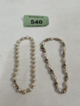 A 18ct pearl bracelet and another in 9ct. 7g gross.