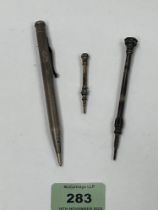 Two silver propelling pencils and a gilt example set with turquoise stones and hardstone matrix.