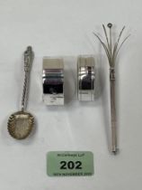A Sterling silver propelling swizzle stick; two silver napkin rings and silver apostle teaspoon.