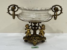 A Napoleon III ormolu and etched glass table centrepiece, the base cast with two winged putti and