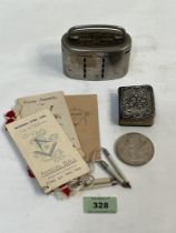 A prayer book, the silver front with Reynolds angels; a Hindu temple token; a Barclays money bank