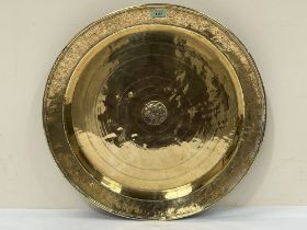 A 19th century Persian brass charger. 23" diam.