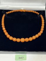 A necklace of graduated amber beads. 19" long approx 26.9g.