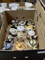 12 miniature ceramic teapots.