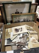 A box of early photographs, some framed