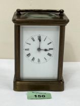 A French brass carriage time piece. 4¾" high.