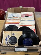 A box of approximately 200 7" vinyl records.