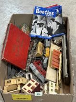 A box of model railway, 1960s Beatles magazines and a album of cigarette cards.