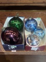 Five coloured metallised glass baubles 6" diam and smaller.