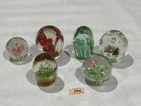 Six glass paperweights.