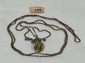 A 9ct chain with a 19th century locket containing a lock of hair, suspended with a gold charm and