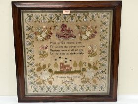 A Victorian needlework sampler by Elizabeth Annie Towers, worked with a church, a lion and flowers