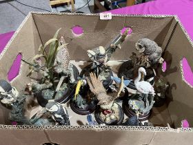 A box of resinous models of birds.