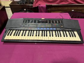 A Yamaha PSR - 47 electronic keyboard.