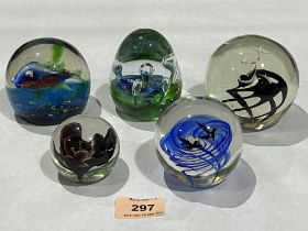 Five glass paperweights.