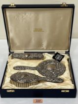 An Elizabeth II cased four piece silver dressing table set.