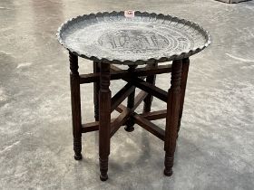 A silvered metal tray top table on folding base. 20" diam.