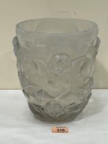 An opalescent glass vase in the style of Lalique, moulded with cherubs in relief. 9¼" high. Chips to