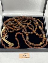 A four strand necklace of amber beads. 128g.