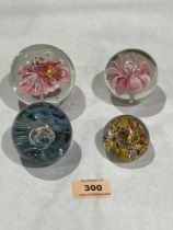 Four glass paperweights.