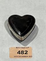 A tortoiseshell and silver mounted heart shaped box. Engraved initials and date 1926. 2" long.