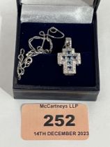 A 9ct white gold aquamarine and diamond cross pendant on 9ct necklet chain. 3.8g gross.