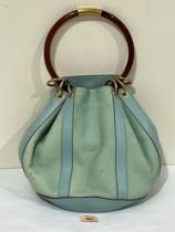 A vintage Gucci leather designer bag with protective outer bag. 18" high including handle.