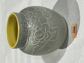 A Bretby ovoid vase, incised with flowers on a drab glaze with yellow interior. Impressed marks