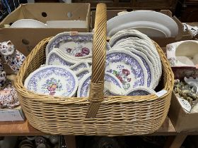 A wicker basket with a collection of Copeland Spode Mayflower ceramics.