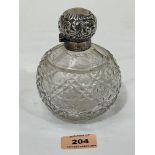 An Edward VII globular cut glass scent bottle with silver mount and repousse lid. Birmingham 1903.