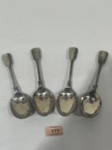A set of four Victorian silver fiddle pattern serving spoons by Walker and Hall. Sheffield 1898.