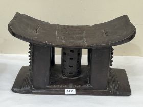 An African tribal carved hardwood stool or head rest. 18" wide.