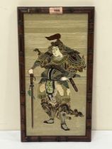 A tube lined ceramic tile depiction of a Japanese warrior. Faux bamboo frame. 16" x 8".