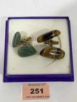 Two pairs of jade or tiger's eye cufflinks of free form.