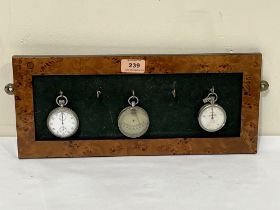 A hydrometer, stopwatch and pedometer on a burr veneered wall plaque. 15½" wide.