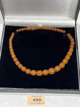 A necklace of graduated amber beads. 19" long approx 26.9g.