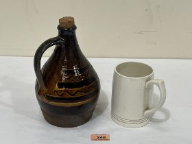 A 1930s Keith Murray for Wedgwood mug, (chips to base) and a studio pottery bottle.