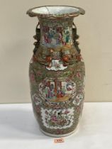 A late 19th century Cantonese famille-rose vase, decorated with cartouches of animated scenes,