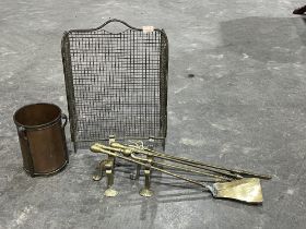 Brass fire irons, a pair of fire dogs, a copper trench art style fireside bucket and a fire guard.