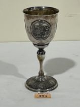 A 19th century Russian plated chalice, the bowl with three coin medallions. 7" high.