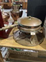 A copper chaffing pan on stand.
