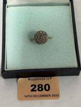 A diamond cluster ring. In gold marked 375. 4g gross. Size P.